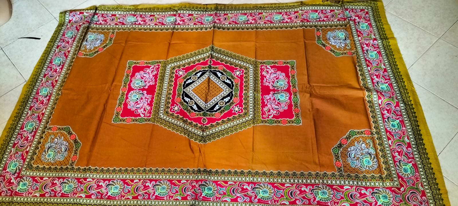Orange kitenge cloth with pink and olive borders